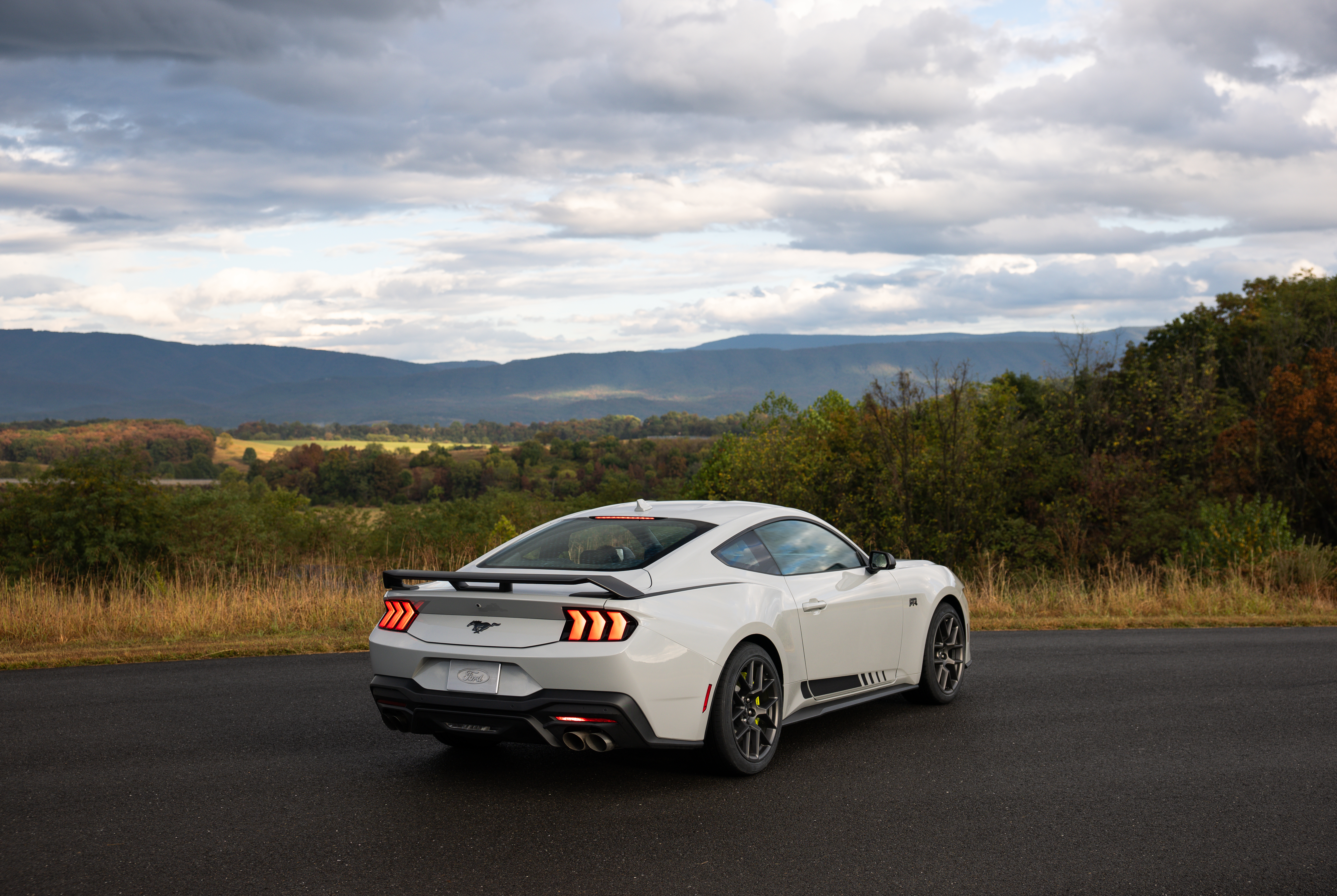 Optional RTR package available on 2026 Ford Mustang EcoBoost fastback. Preproduction model shown with optional Hyper Lime brake caliper shown. Available late spring 2026.